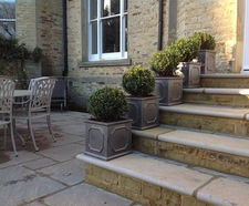 Clayfibre faux lead planters complement sandstone property