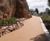 Natural stone surfacing course for cliffside pathway 0