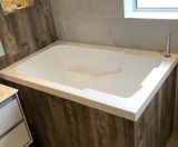 Nirvana deep soaking tub in wood-panelled surround - on this page