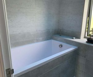 Minimalist deep soaking tub for remodelled bathroom