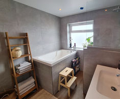 Compact deep soaking tub for family bathroom