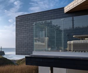 Natural slate rainscreen cladding for coastal home