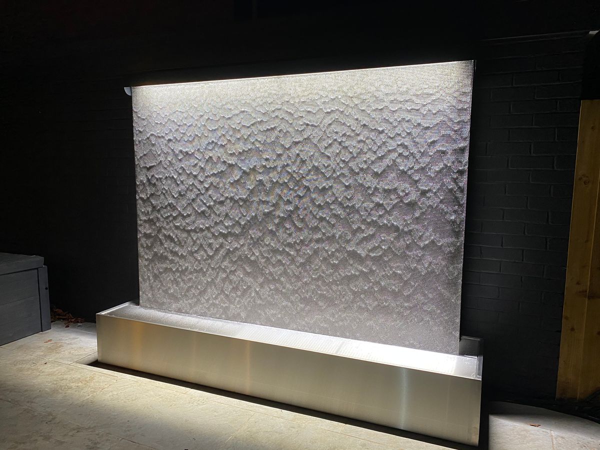 The AquaVeil® luxury bespoke water wall The Enigma™ Tills