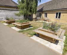 Timber outdoor seating, planters and litter bins for school