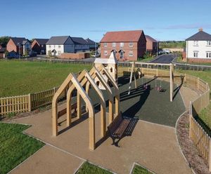 Enclosed community play area with bespoke archways