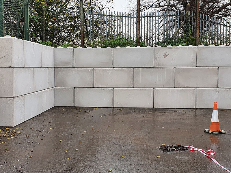 Interlocking concrete block retaining clearance wall