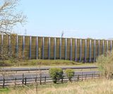 Barrier reduces noise for housing development next to major road - on this page