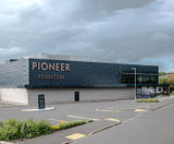 Curved louvred roof screen custom-designed for new foodstore - on this page