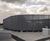 Curved louvred roof screen custom-designed for new foodstore 1