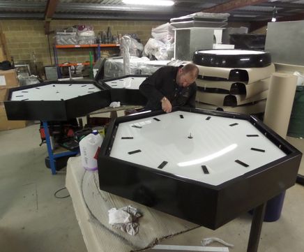 Illuminated hexagonal bezel clocks for telecom structures