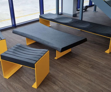 Carved charred oak seating and table for meeting space