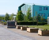 Moveable timber planters and seating for traffic management at campus - on this page