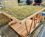 Outdoor classrooms with seating and green roofs for school