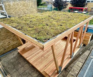 Outdoor classrooms with seating and green roofs for school