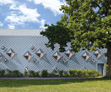 Zinc roof and cladding creates sculptural facade for sports hall - on this page