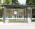 Self - freestanding steel and glass waiting shelter with concrete base 0