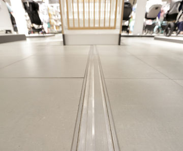 Expansion joints and entrance matting for sports venue