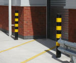 Steel bollard with black and yellow high-visibility hazard bands