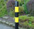 Steel bollard with black and yellow high-visibility hazard bands 1