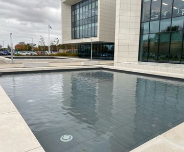 Mirror pools and natural, oval pond created at Fujifilm House