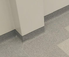 Floormitres, cove formers and capping strips for hospital floors