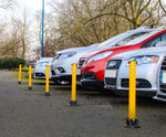 Yellow lockable fold-down steel post for driveways and parking spaces