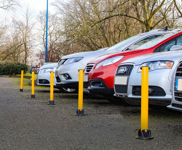 Yellow lockable fold-down steel post for driveways and parking spaces