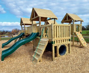 Large wooden climbing frame and swings installed at country park