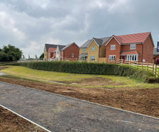 Earth reinforced retaining walls for attenuation ponds