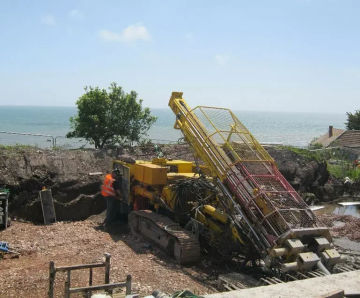 Stabilising and reinforcing sea defence and ground near car park