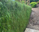 Topsoil-filled bagwork used to created retaining wall in garden - on this page