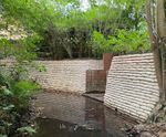 Concrete filled bagwork for retaining walls