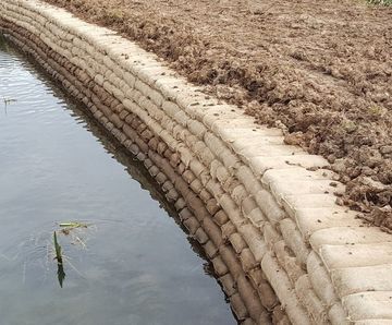 Concrete filled bagwork for placement close to water