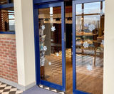 Bi-parting sliding doors provide easy access to new bakery shop  - on this page