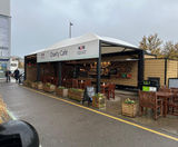 Canopies protect customers at hospital's outdoor charity cafe - on this page