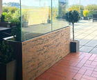 Bespoke UHPC trough planters with integrated glass balustrades