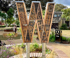 Nature-positive timber bug house sculptures for pocket park - Watford