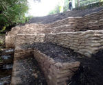 Concrete filled bagwork for use above water