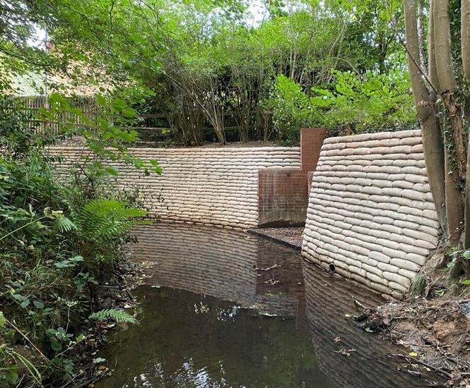 Above water concrete-filled bagwork used in riverbank scour repair