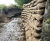 Pre-filled concrete bagwork repairs stream embankment - Dundee 3