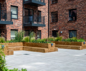 Raised timber planters with integrated seating for residential development