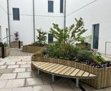 Raised timber planters with integrated bench seating for courtyards - on this page