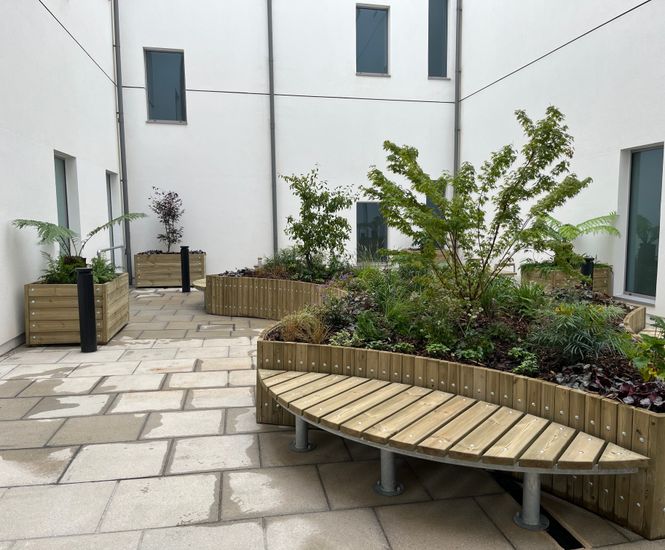 Raised planters and bench seating for hospital courtyards