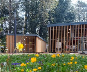 Secure timber-clad cycle hubs with 2-tier cycle racks for university