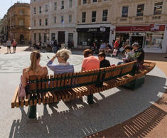 Curved seating with integrated planters for public space