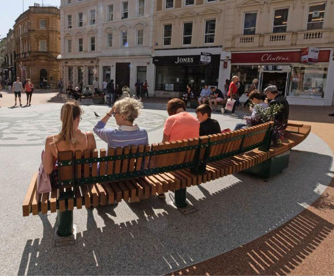 Curved seating with integrated planters for public space