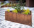 Large wavey corten steel planter beds for public space 4