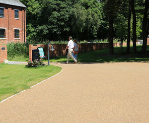 Porous resin bound surfacing for gin distillery grounds
