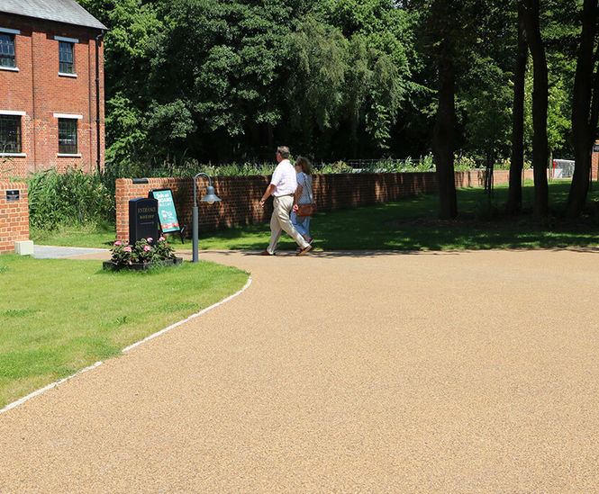 Porous resin bound surfacing for gin distillery grounds