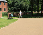 Porous resin bound surfacing for gin distillery grounds
